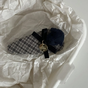 Plaid puppy fabric hair clip with a black ribbon bow and gold LUNA metal tag charm