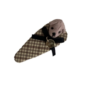 Brown plaid hair clip featuring a plush dog head and black ribbon bow ornament