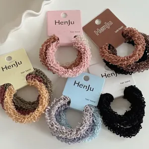 Set of six high-elastic pleated hair scrunchies in earth tones on display card