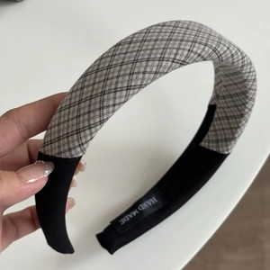 Detailed view of handmade plaid headband with thick padding and soft checkered fabric