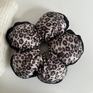 Leopard print leopard flower scrunchie with black lace trim and satin fabric finish