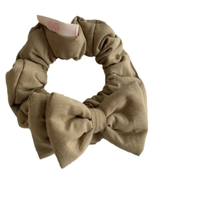 Sweet pink bow scrunchie made of textured linen fabric for stylish ponytail hairstyles