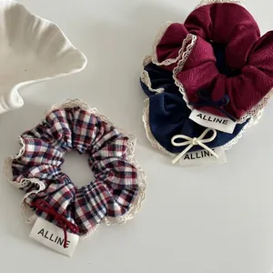 Three-piece red and blue plaid scrunchie set with lace edges and bow detail