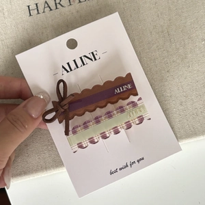 Detailed macro view of blue and brown bow hair clips on branded display packaging card