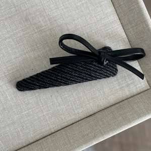 Vintage dark gray knitted hair clip with a black faux leather bow for women