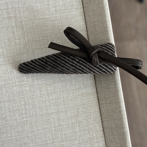 Retro faux leather bow hair clip with textured triangle snap design in dark brown tones