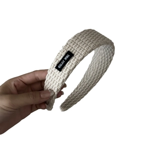 Beige waffle knit headband with black True Fitted label for casual autumn style