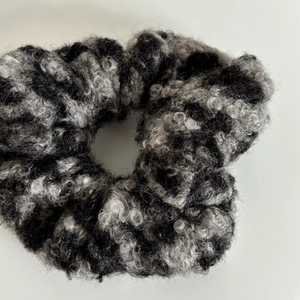 Detailed macro view of the fluffy grey leopard faux fur texture on this plush scrunchie
