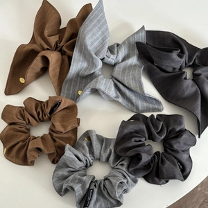 Detailed set of striped fabric hair scrunchies and bow ties in brown and grey tones