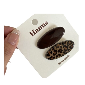 Set of two vintage leopard print and solid coffee brown oval hair clips on display card