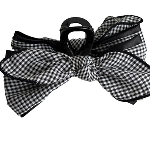Classic black and white checkered bow hair claw clip with sleek black finish for women