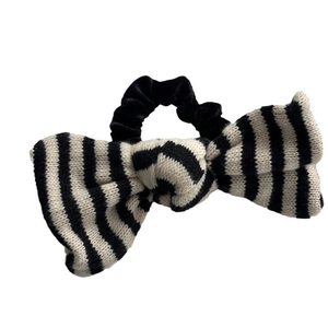 Elegant knit bow hair scrunchie with classic black and white stripes and velvet tie