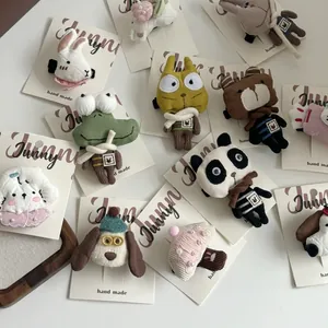 Close-up of handmade 3D cartoon animal hair clips with knitted texture and pearl details