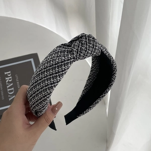 Classic black and white tweed headband with knotted top and elegant checkered texture