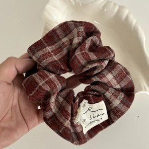Red and grey plaid flannel scrunchie with pearl accent and handmade label detail