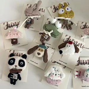 Handmade stuffed fabric animal hair clips including panda and rabbit on display cards