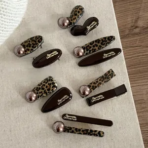 Detailed set of French leopard print and dark chocolate hair clips with elegant gold lettering