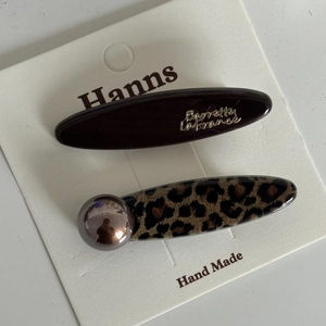 Detailed view of French leopard print and chocolate hair clips set on branding card
