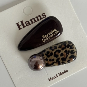 Detail view of French leopard print and chocolate hair clips with decorative pearls