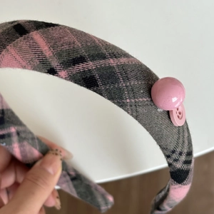 Thick pink and blue checkered headband featuring vintage buttons and retro British style