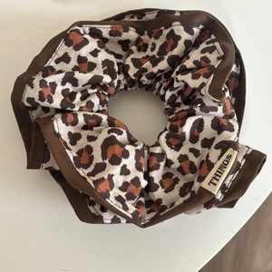 Brown leopard print oversized scrunchie with things woven label and dark brown trim