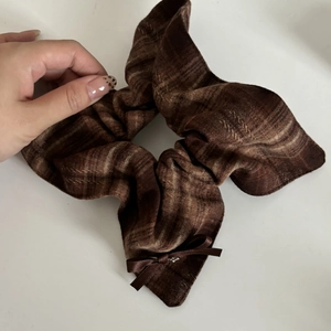 British style brown plaid scrunchie with a silk-textured bow tie on a white background