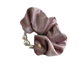 French velvet scrunchie in dusty pink with elegant pearl chain and gold charm detail