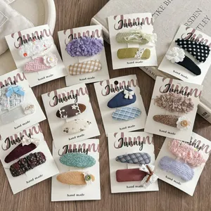 Detailed close-up of handmade fabric hair clips with ribbons and floral patterns