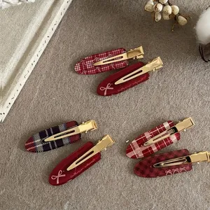 Set of 6 vintage red checkered acetate hair clips with bow patterns on gray texture