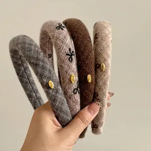 Set of four thick wool flannel headbands with bow embroidery and gold metal love labels