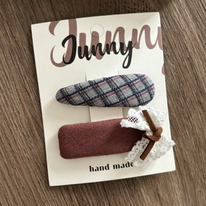 Detail of handmade fabric BB clips with lace bow and plaid pattern on display card