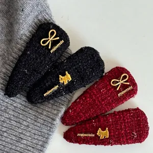Elegant wool fabric hair clip set with golden puppy and bow metallic accents in black and burgundy