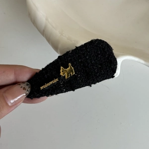 Elegant black tweed hair clip featuring a golden puppy motif and letter detail