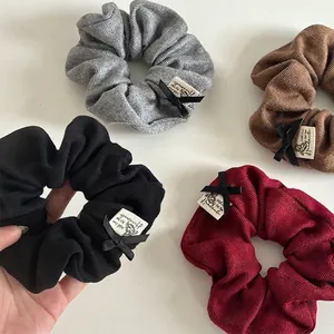 Knitted ribbon scrunchies set in black, grey, brown, and burgundy with handmade bow detail