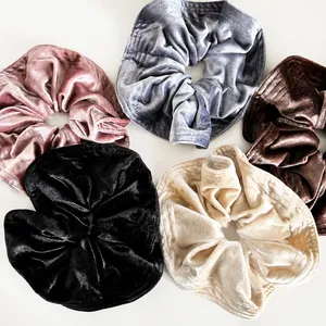 Detailed texture of 5 pack large velvet scrunchies in assorted vintage colors