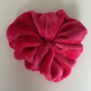 Oversized rose red plush scrunchie made of soft coral fleece for elegant hair styling