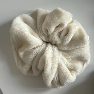 Oversized fluffy cream plush scrunchie in soft coral fleece for autumn and winter hairstyles