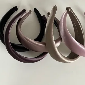 Detail of satin headbands with silk luster showing handmade labels and inner lining