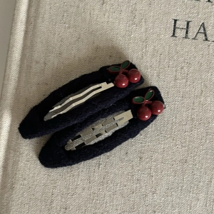Japanese style navy blue hair clips with cute red cherry design on black fabric base