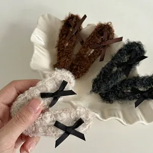 Plush faux fur bow hair clip set including brown, black, and beige hairpins for women