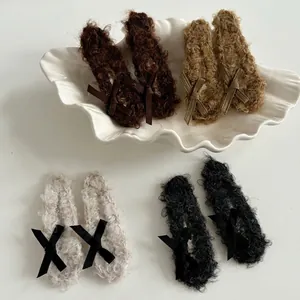 Plush faux fur hair clips with ribbons set in brown, beige, and black for autumn