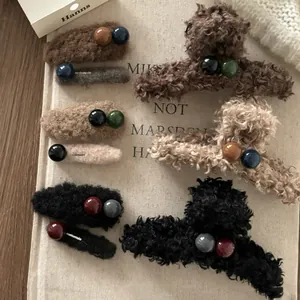 Dettaglio del set di fermagli invernali in peluche con perline colorate morbide