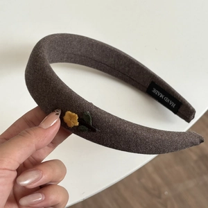 Brown knitted headband with flower embroidery and sponge padding for women