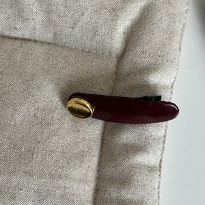 Deep burgundy glossy hair clip featuring an elegant gold Paris engraved metal plate