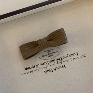 Vintage coffee brown corduroy bow hair clip with a textured woven fabric finish