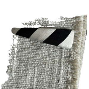Classic black and white striped fabric BB hair clip on a textured tweed surface