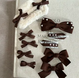 Detailed flat lay of 11-piece brown velvet hair bows set with pearls and lace