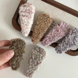 Set of six vintage plush knit BB hair clips in various colors on a linen display tray