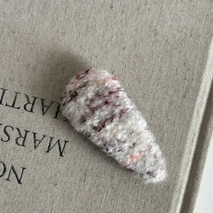 Minimalist plush knit BB hair clip in beige with red-brown and orange fiber accents