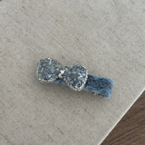 Blue tweed bow hair clip featuring a cluster of crystal stones and small rhinestone accents